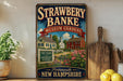 A vintage-style metal sign for the Strawberry Banke Museum Gardens in Portsmouth, New Hampshire, featuring a colorful illustration of a historic house surrounded by flowers and a path leading to the entrance.