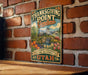 A vintage-style metal sign with a garden scene and text, mounted on a brick wall.