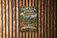 A vintage-style metal sign for Thanksgiving Point Gardens in Utah, featuring a scenic landscape with a waterfall and colorful flowers.