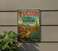 A vintage-style metal sign for the Tucson Botanical Gardens in Arizona, featuring a desert landscape with cacti, flowers, and mountains.