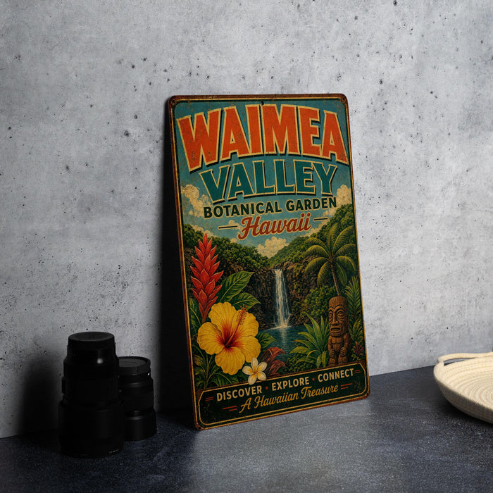 A vintage-style metal sign for Waimea Valley Botanical Garden in Hawaii, featuring colorful illustrations of tropical plants and a waterfall.