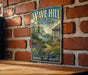 A vintage-style metal sign with the text "WAVE HILL NEW YORK" and a scenic illustration of a garden, mounted on a brick wall.