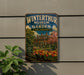 A vintage metal sign for the Winterthur Museum and Garden in Delaware, featuring an illustration of a historic building surrounded by a garden with tulips.