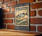 A vintage-style stamp featuring a bluefish is displayed on a brick wall.