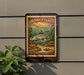 a vintage-style metal sign with a fish illustration, mounted on a wall next to a plant.