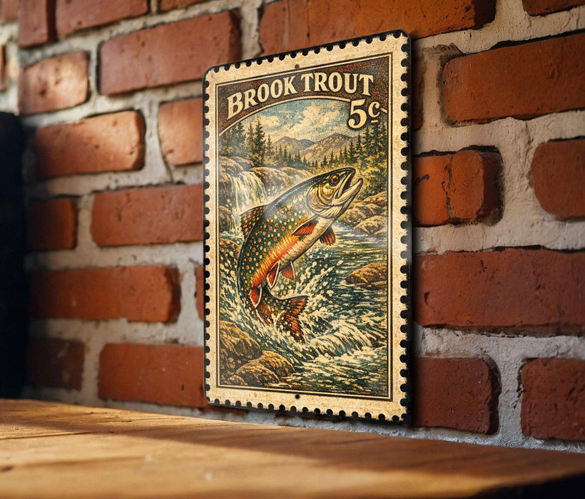 A framed image of a fish, likely a Brook Trout, is mounted on a brick wall.