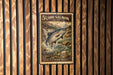 A 5c postage stamp featuring a salmon leaping out of a river, with the text "5COHO SALMON (SILVER)" and "WILDLIFE OF NORTH AMERICA" printed on it.