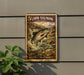a framed poster of a salmon leaping out of a river, with a lush green plant to the left.