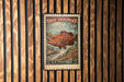 A U.S. postage stamp featuring a large red fish, likely a grouper, against a wooden background.