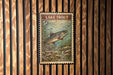 A vintage-style stamp depicting a lake trout, with the text "LAKETROUT" and the denomination of 5 cents.