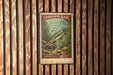 A vintage-style postage stamp from Longnose Gar, featuring a fish illustration, is displayed on a wooden wall.