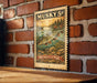 A metal sign with a painting of a muskrat on a brick wall.