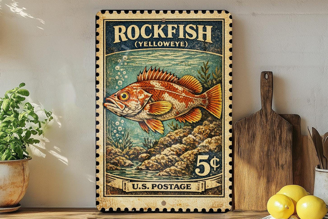 A vintage-style postage stamp featuring a colorful illustration of a rockfish, with the text "ROCKFISH (YELLOWEYE)" and "U.S. POSTAGE" printed on it. The stamp is displayed on a shelf next to a wooden cutting board and a potted plant.