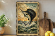 a framed painting of a sailfish leaping out of the water, with a wooden paddle and a potted plant to the side.