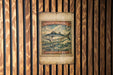 A vintage Spanish mackerel stamp is displayed on a wooden wall, featuring a fish illustration and the text "Spanish Mackerel 5c".