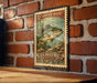 A vintage U.S. postage stamp featuring a spotted bass fish is displayed on a brick wall.