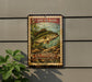A vintage-style metal sign advertising "5¢ Spotted Bass" from the U.S. Postage, featuring a detailed illustration of a spotted bass fish swimming in the water.