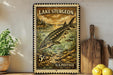 A vintage-style stamp depicting a sturgeon fish, with the text "Lake Sturgen" and "U.S. Postage" printed on it. The stamp is placed on a shelf next to a wooden cutting board and a potted plant.