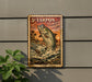 A framed poster of a fish jumping out of the water, with a tropical background, is displayed on a wall.