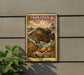 A vintage postage stamp featuring a large fish, with the text "TRIPLETAIL 6¢" and "U.S. POSTAGE" printed on it. The stamp is mounted on a gray wall, and there is a plant to the left of the stamp.