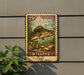 A weathered U.S. postage stamp featuring a walleye fish, mounted on a wall next to a plant.