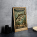 A weathered, vintage-style postage stamp featuring a fish, placed on a dark surface next to some black objects.