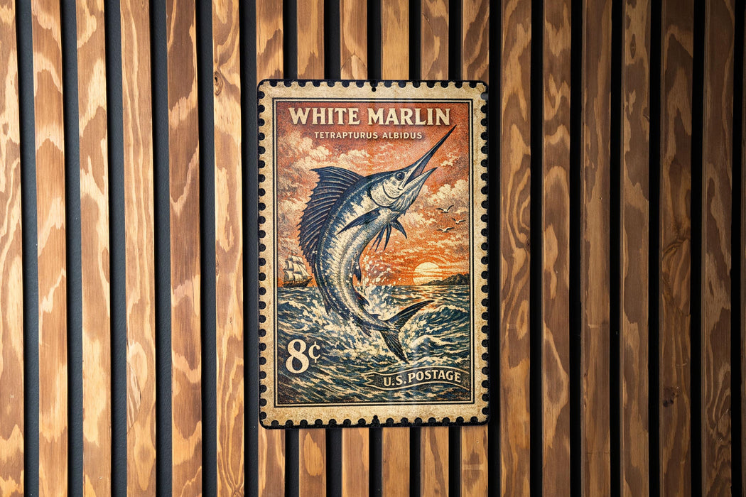 A vintage-style postage stamp featuring a large white marlin fish against a sunset background, mounted on a wooden wall.