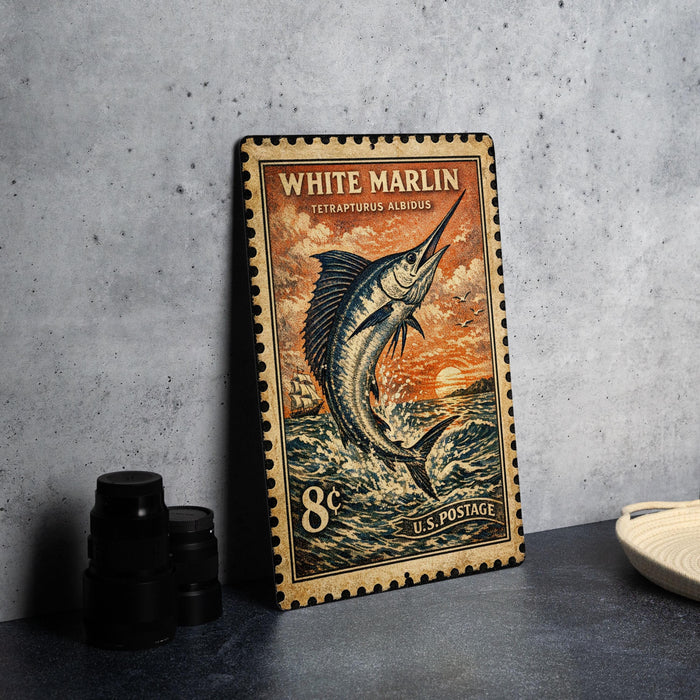 A vintage-style postage stamp featuring a white marlin fish, placed on a dark surface next to some black camera lenses.