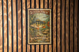 A 5¢ yellow perch postage stamp is displayed on a wooden wall.