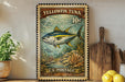 A vintage-style postage stamp featuring a yellowfin tuna fish, with a price of 10 cents, is displayed on a wooden surface next to a wooden cutting board and a potted plant.