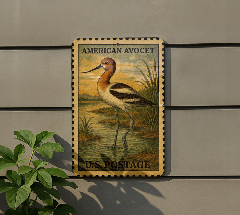 A vintage American Avocet postage stamp is displayed on a wall, featuring a detailed illustration of the bird in a natural setting.