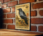 A vintage U.S. postage stamp featuring an American crow perched on a branch, mounted on a brick wall.
