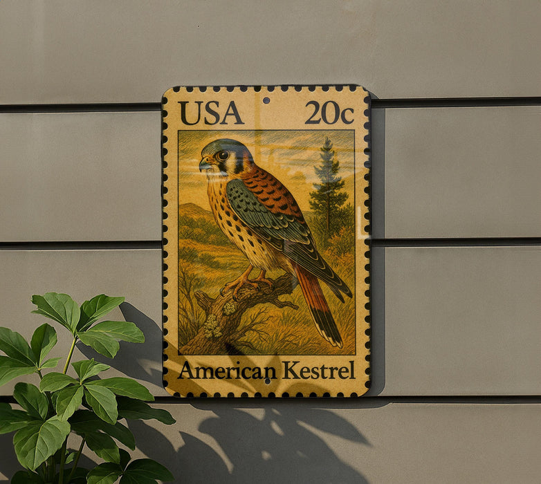 A postage stamp featuring an illustration of an American Kestrel bird, a type of bird of prey, perched on a branch.