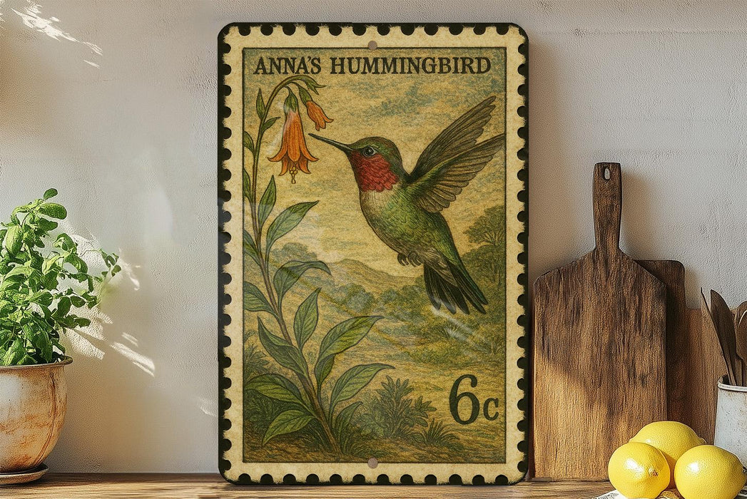 A framed postage stamp depicting a hummingbird is displayed on a shelf next to a wooden cutting board and some potted plants.
