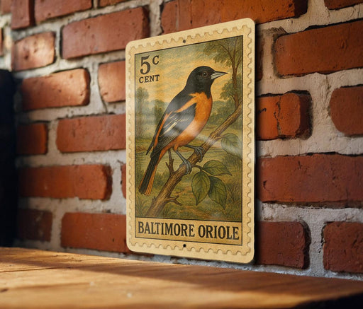 A Baltimore Oriole postage stamp is displayed on a brick wall, featuring a detailed illustration of the bird perched on a branch.