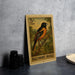 A 5 cent Baltimore Orioles postage stamp is displayed on a table, featuring an illustration of a Baltimore Oriole bird perched on a branch.