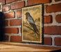 A framed illustration of a barn swallow is displayed on a brick wall, featuring a detailed illustration of the bird perched on a branch.