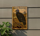 A postage stamp featuring a black vulture is displayed on a wall, with a plant visible to the left.