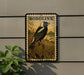 A postage stamp featuring a black and white bird, likely a Bobolink, is displayed on a wall.