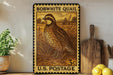 A framed vintage U.S. postage stamp depicting a quail bird, with a wooden cutting board and lemons visible in the background.