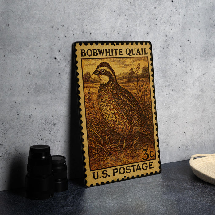 A vintage Bobwhite Quail postage stamp from the U.S. Postal Service, featuring a detailed illustration of the bird in a grassy field.