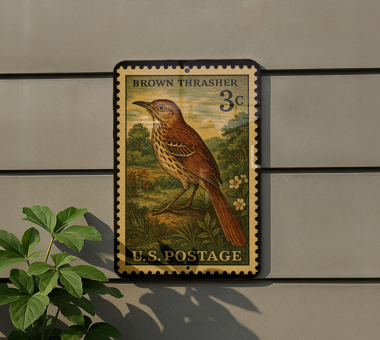 A vintage brown thrasher postage stamp from the U.S. Postal Service, featuring a detailed illustration of a brown thrasher bird perched on a rock.