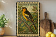 A vintage U.S. postage stamp featuring a colorful illustration of a yellow and black oriole bird perched on a branch, with a potted plant and wooden cutting board in the background.