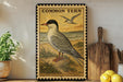 a framed illustration of a Common Tern, a bird with a distinctive appearance, standing on a beach with a bird in flight in the background.