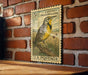 A vintage U.S. postage stamp featuring a yellow and black bird perched on a branch, mounted on a brick wall.
