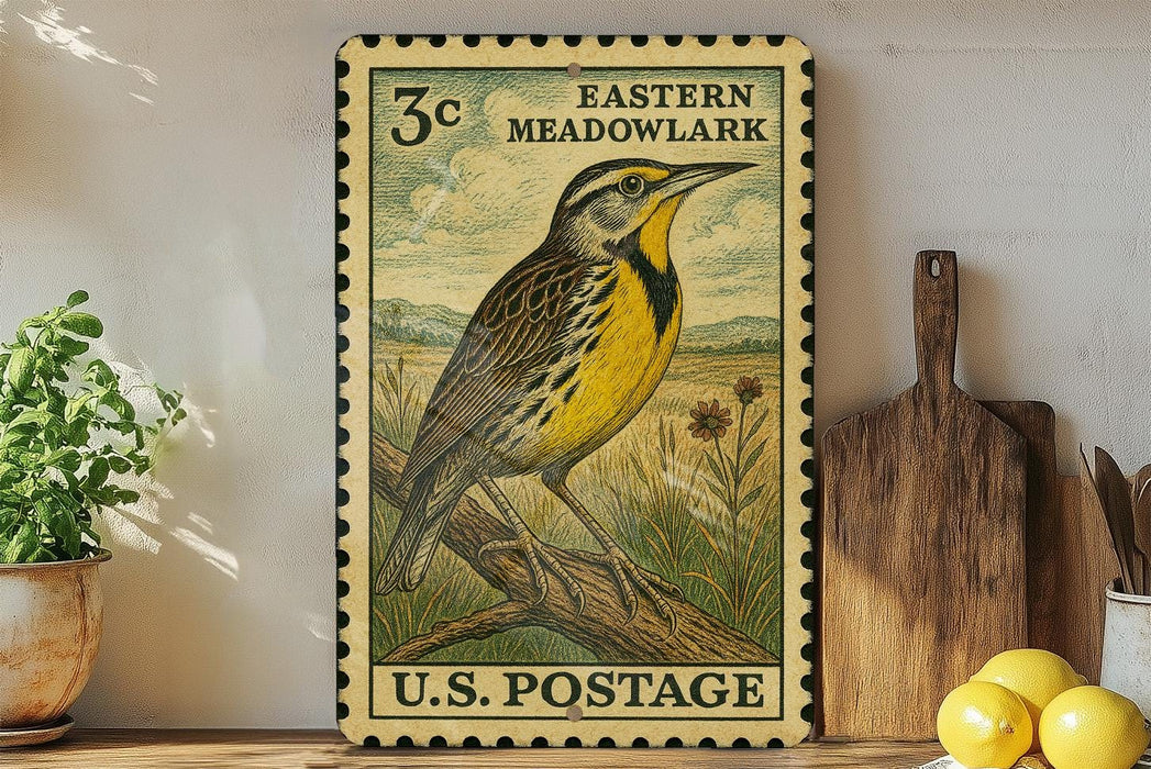 A vintage-style postage stamp from the United States, featuring a yellow and black bird perched on a branch, is displayed on a shelf next to a wooden cutting board and some potted plants.