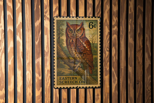 A postage stamp featuring an illustration of an Eastern Screech Owl, which is a type of owl native to the eastern United States and Canada.