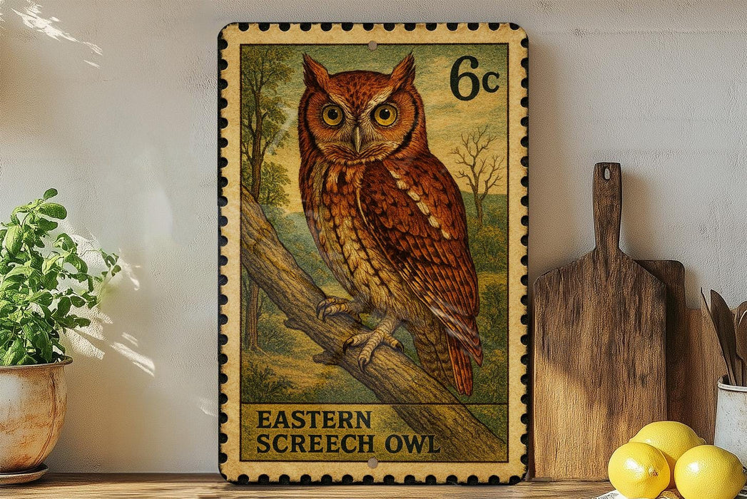 A framed stamp depicting an Eastern Screech Owl, with the text "EASTERN SCREECH OWL" printed on it. The stamp is placed on a shelf next to a wooden cutting board and a potted plant.