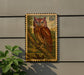 a stamp-like artwork of an Eastern Screech Owl perched on a branch, mounted on a wall.