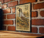 A vintage-style postage stamp featuring a quail bird, mounted on a brick wall.
